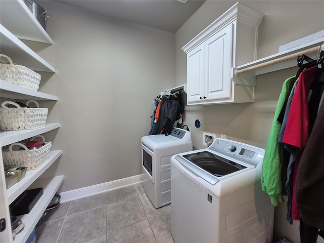 7106 Prairie Grass Ln, Katy, TX 77493 - laundry room featuring washer and dryer, cabinet space, baseboards, and light tile patterned floors