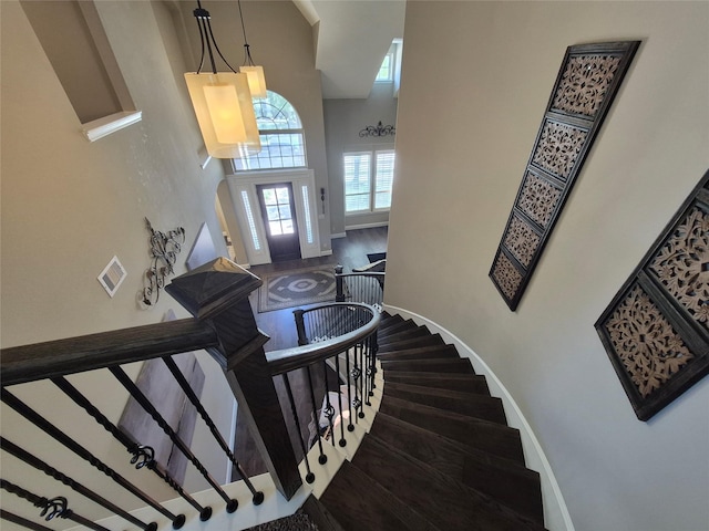 7106 Prairie Grass Ln, Katy, TX 77493 - staircase featuring baseboards, a high ceiling, and wood finished floors