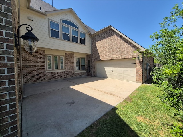 7106 Prairie Grass Ln, Katy, TX 77493 - rear view of house with an attached garage, concrete driveway, and brick siding