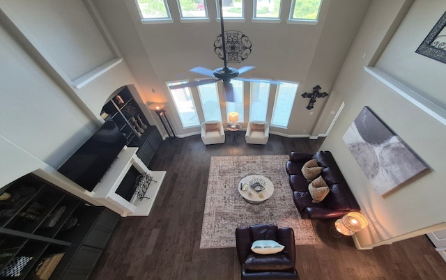 7106 Prairie Grass Ln, Katy, TX 77493 - living room featuring healthy amount of natural light, wood finished floors, a high ceiling, and a ceiling fan