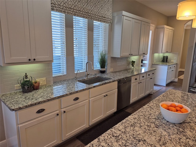7106 Prairie Grass Ln, Katy, TX 77493 - kitchen featuring a sink, dishwasher, and light stone countertops