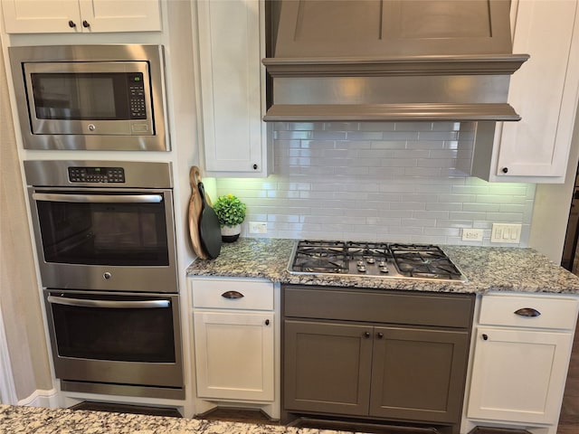 7106 Prairie Grass Ln, Katy, TX 77493 - kitchen featuring appliances with stainless steel finishes, light stone countertops, and tasteful backsplash