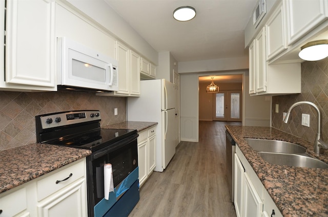 kitchen with tasteful backsplash, light wood-type flooring, white cabinetry, stainless steel appliances, and a sink