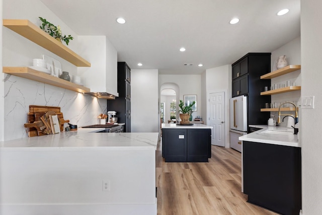26719 Outback Dr, Katy, TX 77493 - kitchen featuring dark cabinets, high end white refrigerator, recessed lighting, open shelves, and a sink