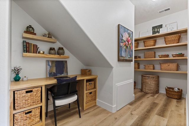 26719 Outback Dr, Katy, TX 77493 - home office featuring light wood-type flooring, visible vents, built in study area, lofted ceiling, and baseboards