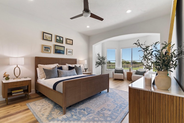 26719 Outback Dr, Katy, TX 77493 - bedroom with ceiling fan, light wood finished floors, arched walkways, and recessed lighting