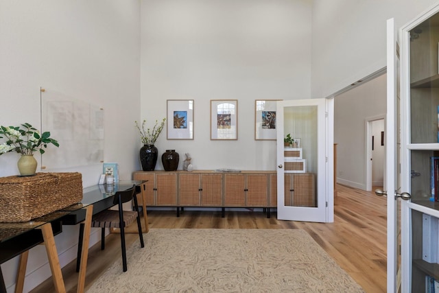 26719 Outback Dr, Katy, TX 77493 - interior space with french doors, wood finished floors, and a towering ceiling