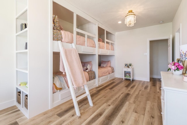 26719 Outback Dr, Katy, TX 77493 - bedroom with light wood-style flooring, a notable chandelier, baseboards, and recessed lighting