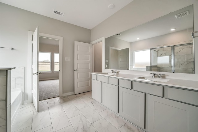 1014 Wildflower Way Dr, Beasley, TX 77417 - full bath featuring marble look tiles, double vanity, a garden tub, an enclosed shower, and baseboards