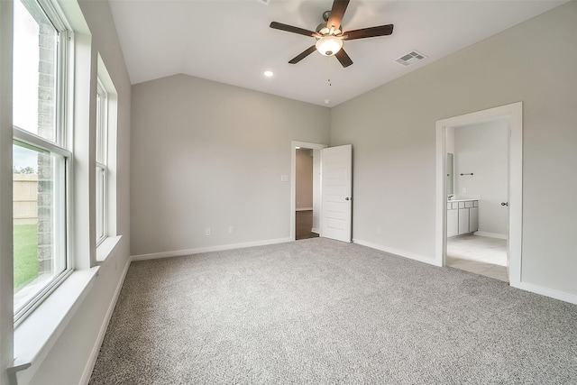 1014 Wildflower Way Dr, Beasley, TX 77417 - unfurnished bedroom featuring carpet, lofted ceiling, baseboards, connected bathroom, and ceiling fan