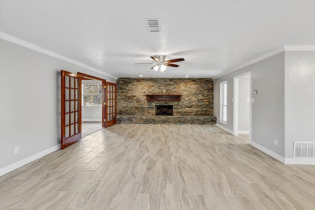 unfurnished living room featuring a healthy amount of sunlight, visible vents, and ceiling fan