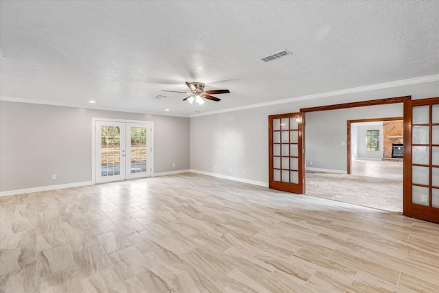 spare room featuring ornamental molding, baseboards, visible vents, a ceiling fan, and french doors