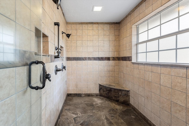bathroom with tile walls and tiled shower