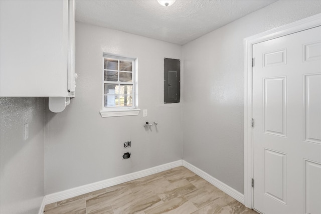 laundry area with a textured ceiling, electric panel, laundry area, and baseboards