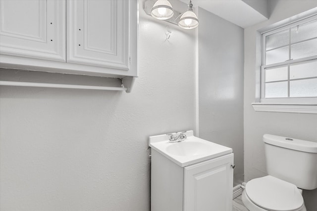 half bathroom featuring toilet and vanity