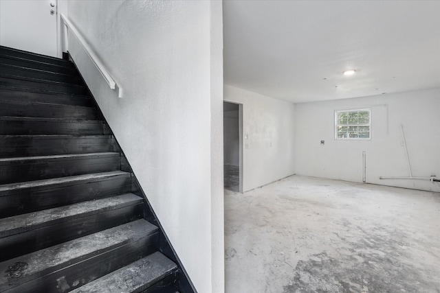 stairs featuring concrete floors