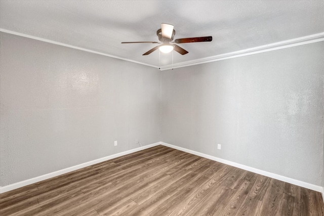 unfurnished room featuring a ceiling fan, wood finished floors, and baseboards