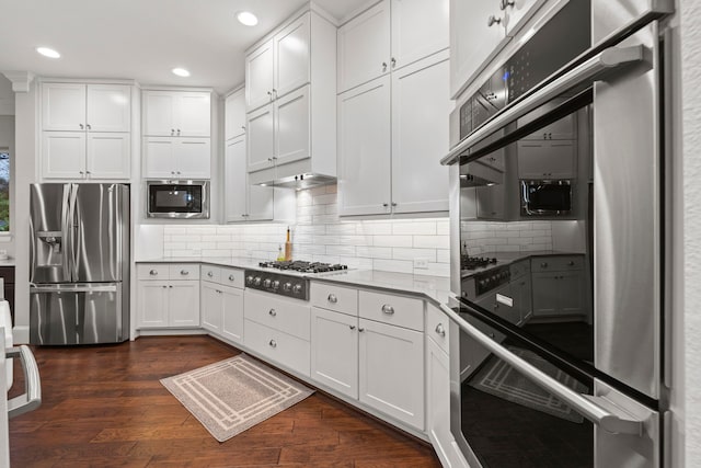 6931 Harvest Ln, Katy, TX 77493 - kitchen featuring white cabinets, dark wood finished floors, and appliances with stainless steel finishes