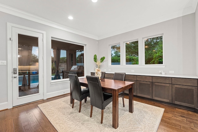6931 Harvest Ln, Katy, TX 77493 - dining room with ornamental molding, baseboards, recessed lighting, and hardwood / wood-style flooring