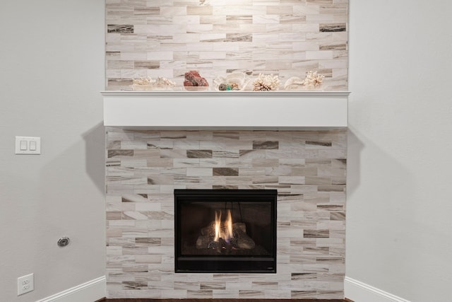 6931 Harvest Ln, Katy, TX 77493 - details featuring a tiled fireplace and baseboards