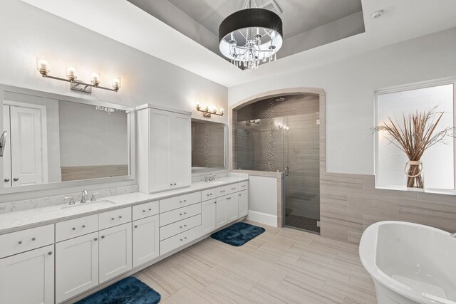 6931 Harvest Ln, Katy, TX 77493 - bathroom with a freestanding tub, double vanity, a sink, and a stall shower