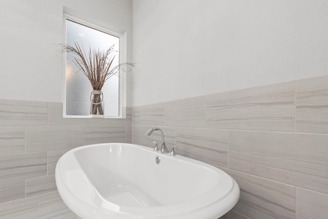 6931 Harvest Ln, Katy, TX 77493 - bathroom with tile walls and a soaking tub