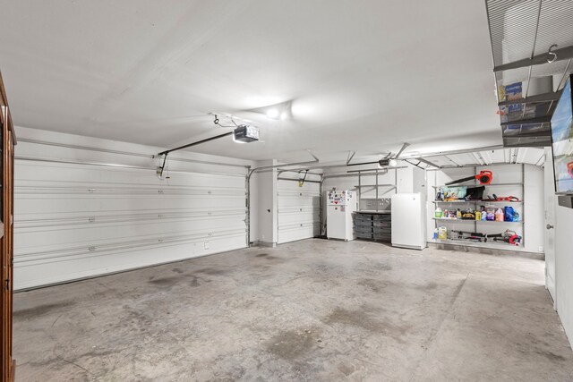 6931 Harvest Ln, Katy, TX 77493 - garage featuring a garage door opener and freestanding refrigerator