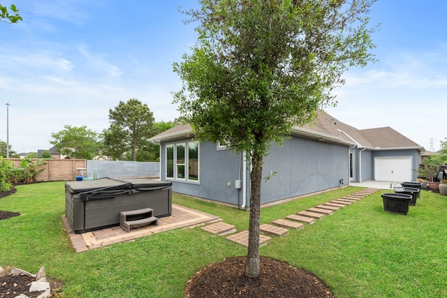 6931 Harvest Ln, Katy, TX 77493 - back of property featuring a yard, an attached garage, fence, and a hot tub