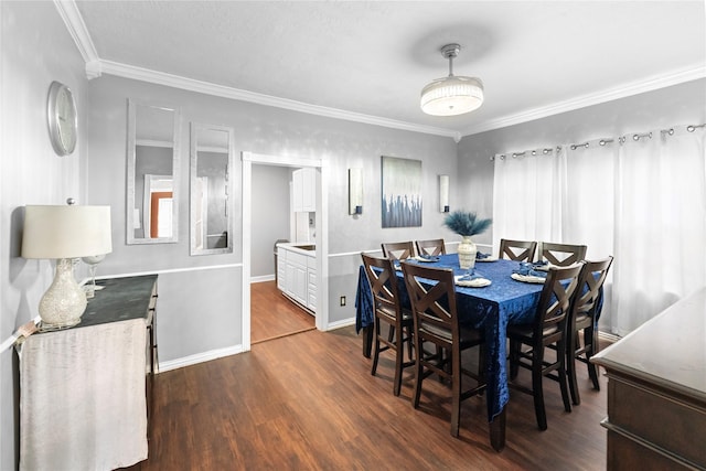 6503 Ave C, Houston, TX 77011 - dining area featuring baseboards, crown molding, and dark wood finished floors