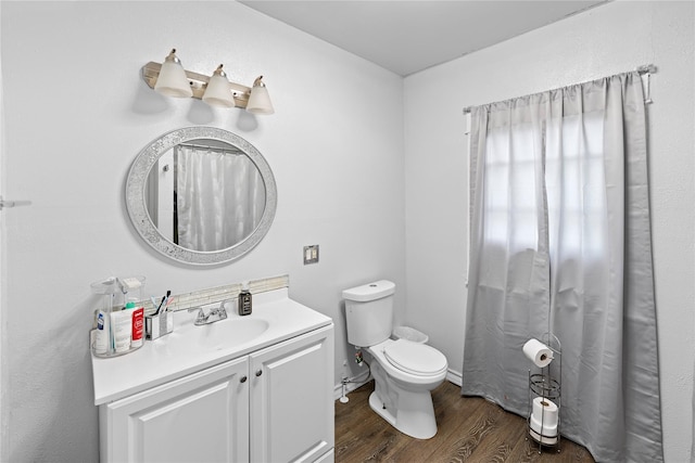6503 Ave C, Houston, TX 77011 - bathroom featuring vanity, toilet, and wood finished floors