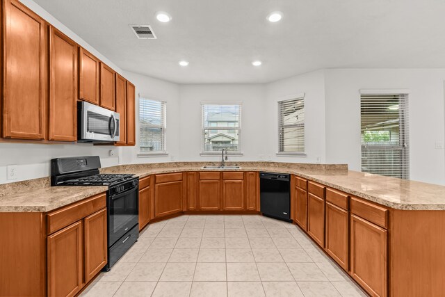 15922 Copper Springs Ln, Houston, TX 77084 - kitchen featuring a peninsula, a sink, visible vents, black appliances, and light countertops