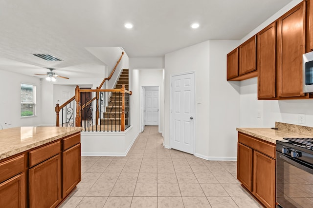 15922 Copper Springs Ln, Houston, TX 77084 - kitchen featuring black range with gas stovetop, brown cabinets, light countertops, and recessed lighting