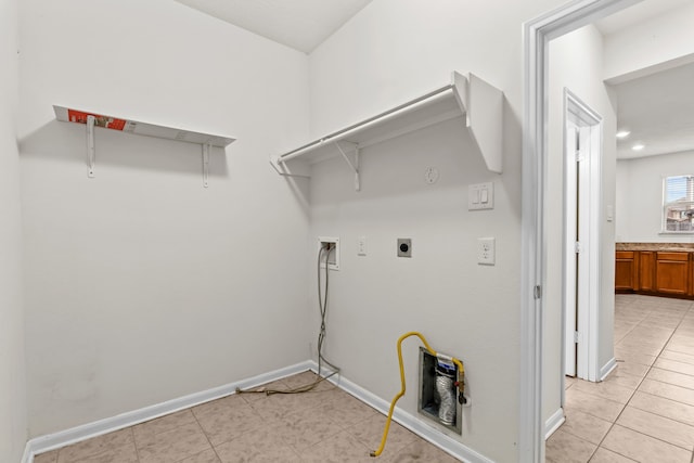 15922 Copper Springs Ln, Houston, TX 77084 - laundry room featuring light tile patterned floors, baseboards, hookup for a washing machine, hookup for an electric dryer, and laundry area