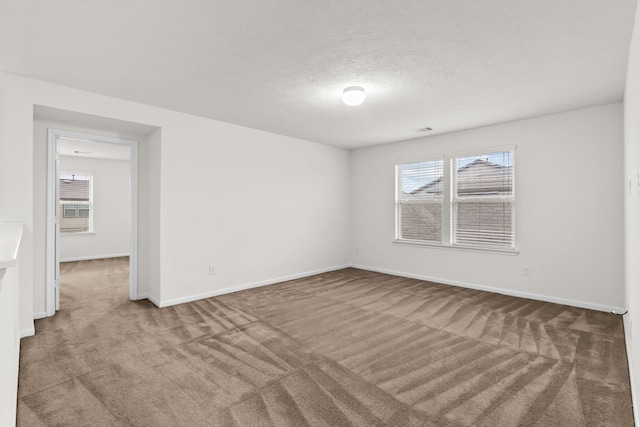 15922 Copper Springs Ln, Houston, TX 77084 - carpeted spare room featuring plenty of natural light, baseboards, and a textured ceiling