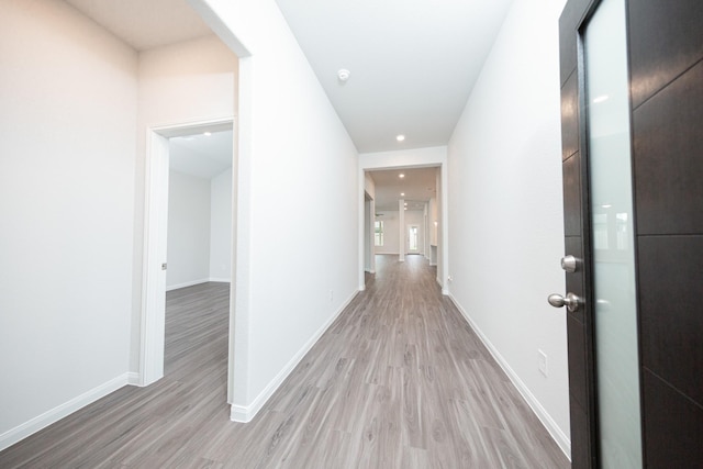 3001 Plains Cir, Brookshire, TX 77423 - hall featuring light wood-style flooring, baseboards, and arched walkways