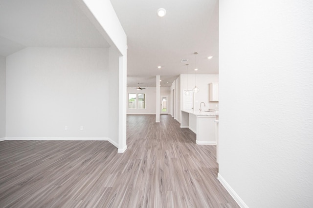 3001 Plains Cir, Brookshire, TX 77423 - corridor with light wood-style floors, baseboards, a sink, and recessed lighting