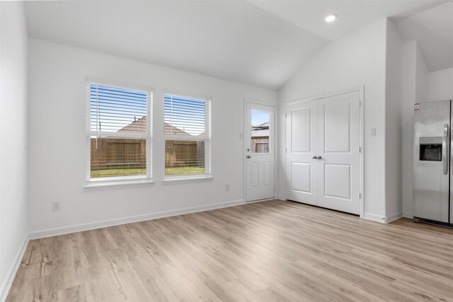3319 Meadknoll Ln, Richmond, TX 77406 - unfurnished bedroom with stainless steel fridge with ice dispenser, vaulted ceiling, light wood finished floors, baseboards, and a closet