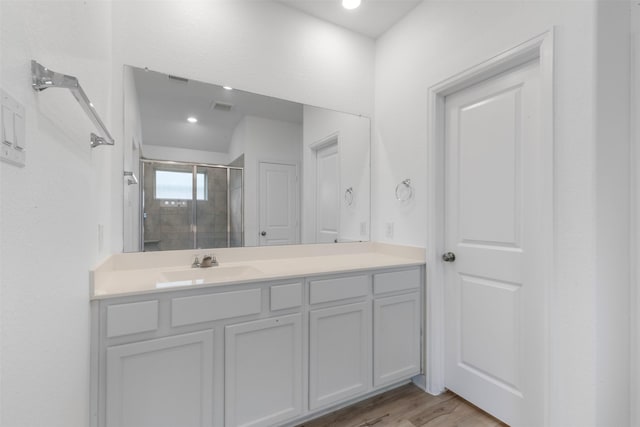 3319 Meadknoll Ln, Richmond, TX 77406 - full bathroom with a stall shower, vanity, wood finished floors, and recessed lighting