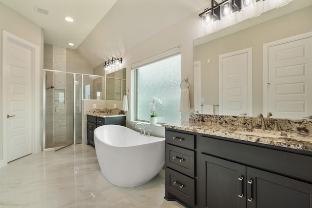 full bath with a freestanding bath, recessed lighting, marble finish floor, a shower stall, and vanity