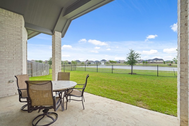 view of patio / terrace with a fenced backyard, a residential view, and outdoor dining space