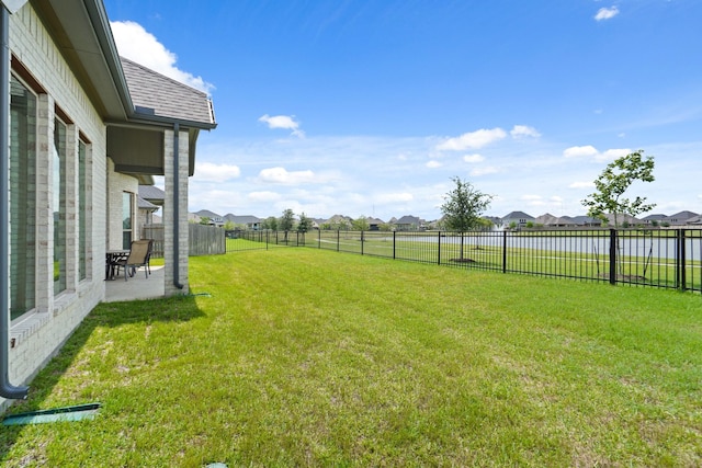 view of yard featuring a patio area, a residential view, and a fenced backyard