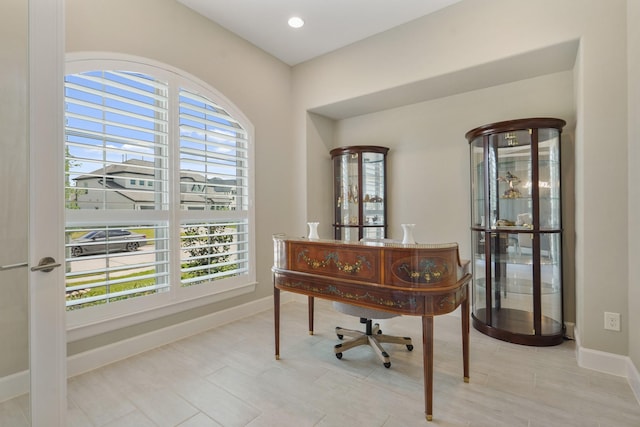 home office featuring a wealth of natural light and baseboards