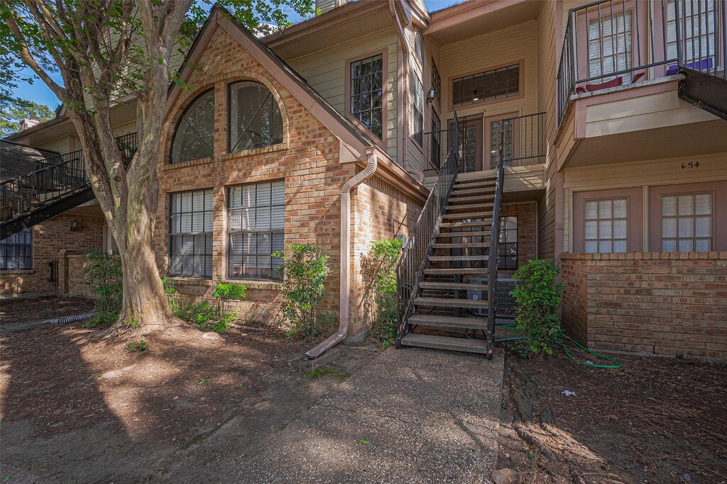 16800 Sugar Pine Dr Unit G58, Houston, TX 77090 - view of side of home with brick siding and stairs