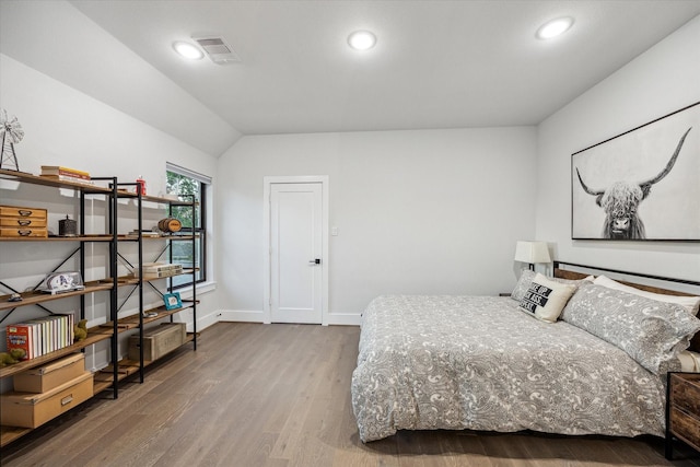 bedroom featuring visible vents, baseboards, recessed lighting, and wood finished floors