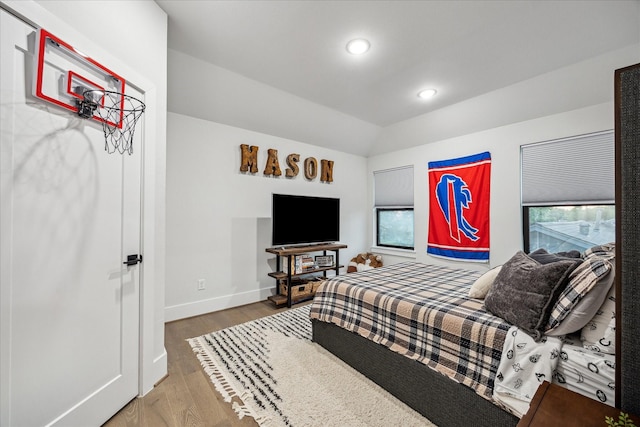 bedroom featuring wood finished floors, baseboards, vaulted ceiling, and recessed lighting