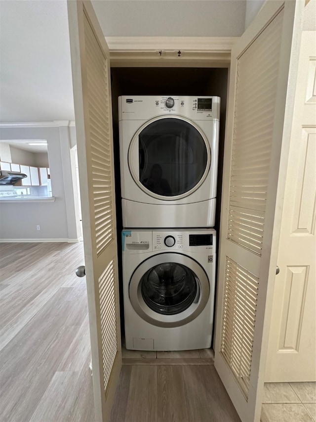 6289 Wilcrest Dr Unit 2203, Houston, TX 77072 - laundry area with laundry area, wood finished floors, and stacked washer and clothes dryer