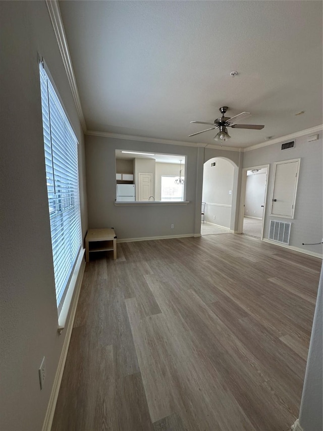 6289 Wilcrest Dr Unit 2203, Houston, TX 77072 - unfurnished living room with ceiling fan, arched walkways, ornamental molding, visible vents, and wood finished floors