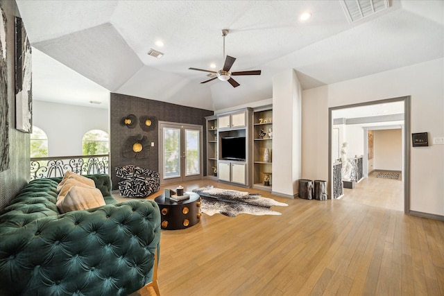 22009 Holly Creek Trl, Tomball, TX 77377 - living area featuring light wood-type flooring, ceiling fan, vaulted ceiling, and visible vents