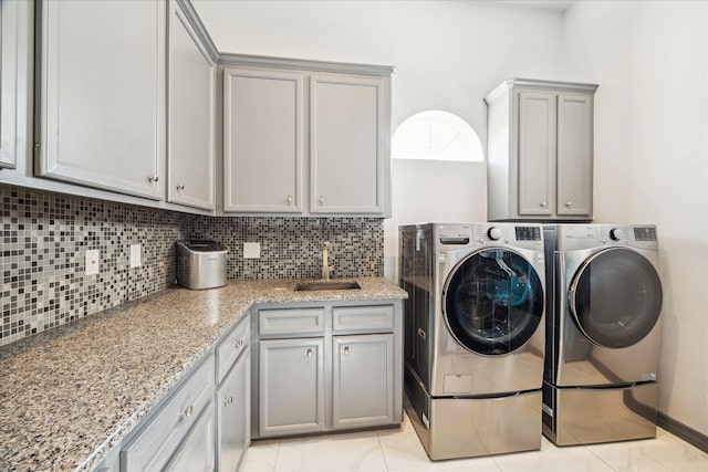 22009 Holly Creek Trl, Tomball, TX 77377 - laundry area featuring a sink, cabinet space, and washing machine and dryer
