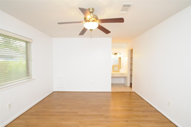 1110 Holly Dr, Conroe, TX 77301 - unfurnished room featuring a ceiling fan, baseboards, visible vents, and light wood-style floors
